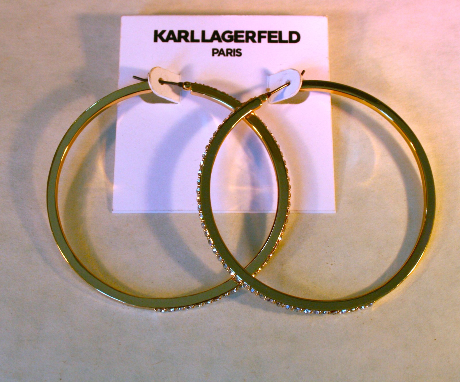 Karl Lagerfeld Paris gold tone Pave crystal edged Hoop Earrings 2 1/2″