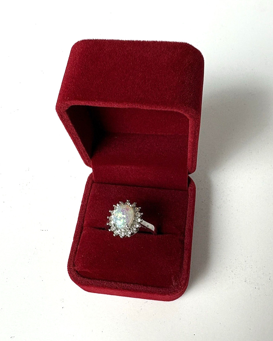 Silver Tone Ring with Opal Color Oval Cabochon Surrounded by White Rhinestones
