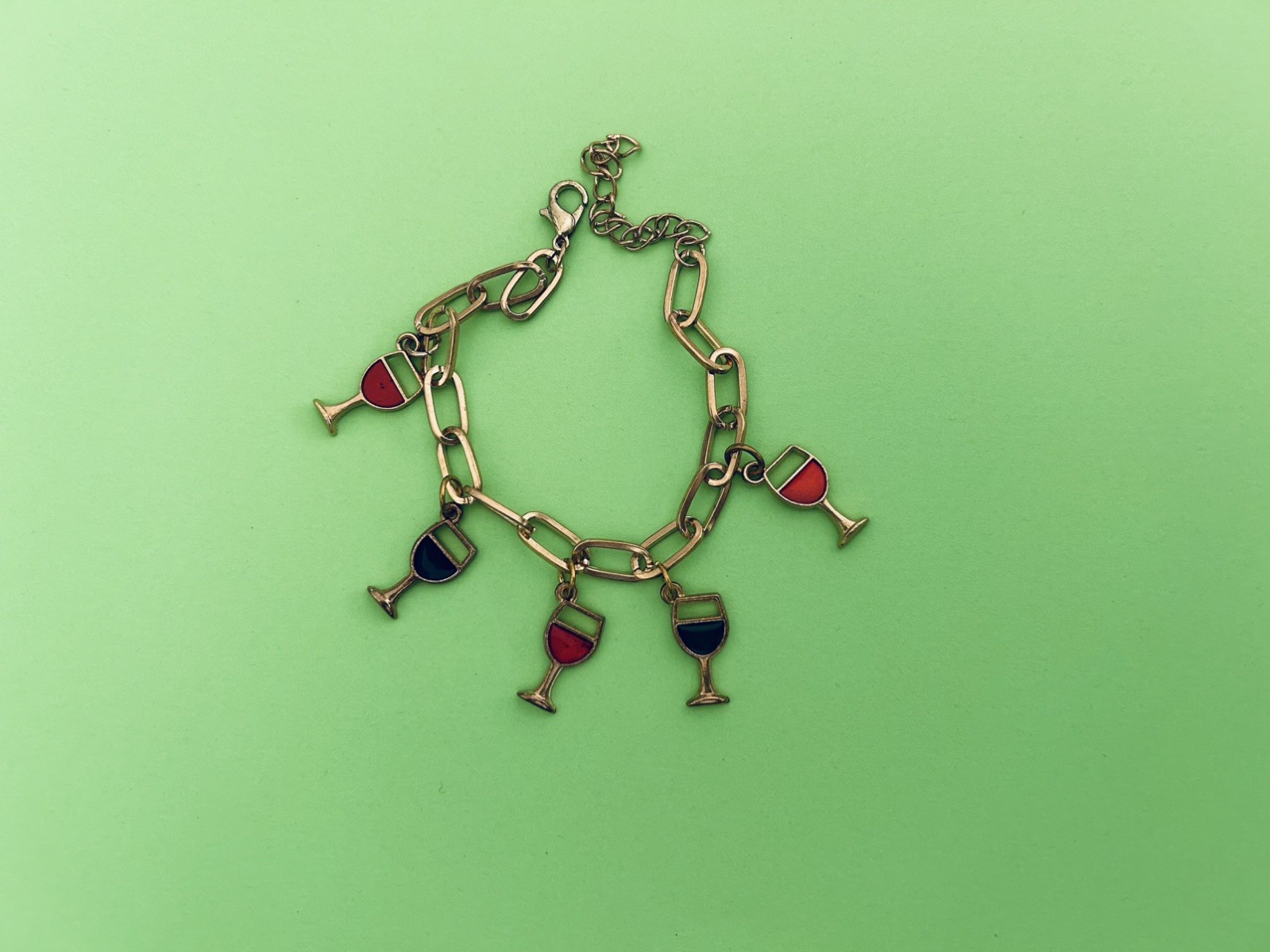 multicolored red, green & blue wine charm bracelet on 8.5” gold tone adj chain