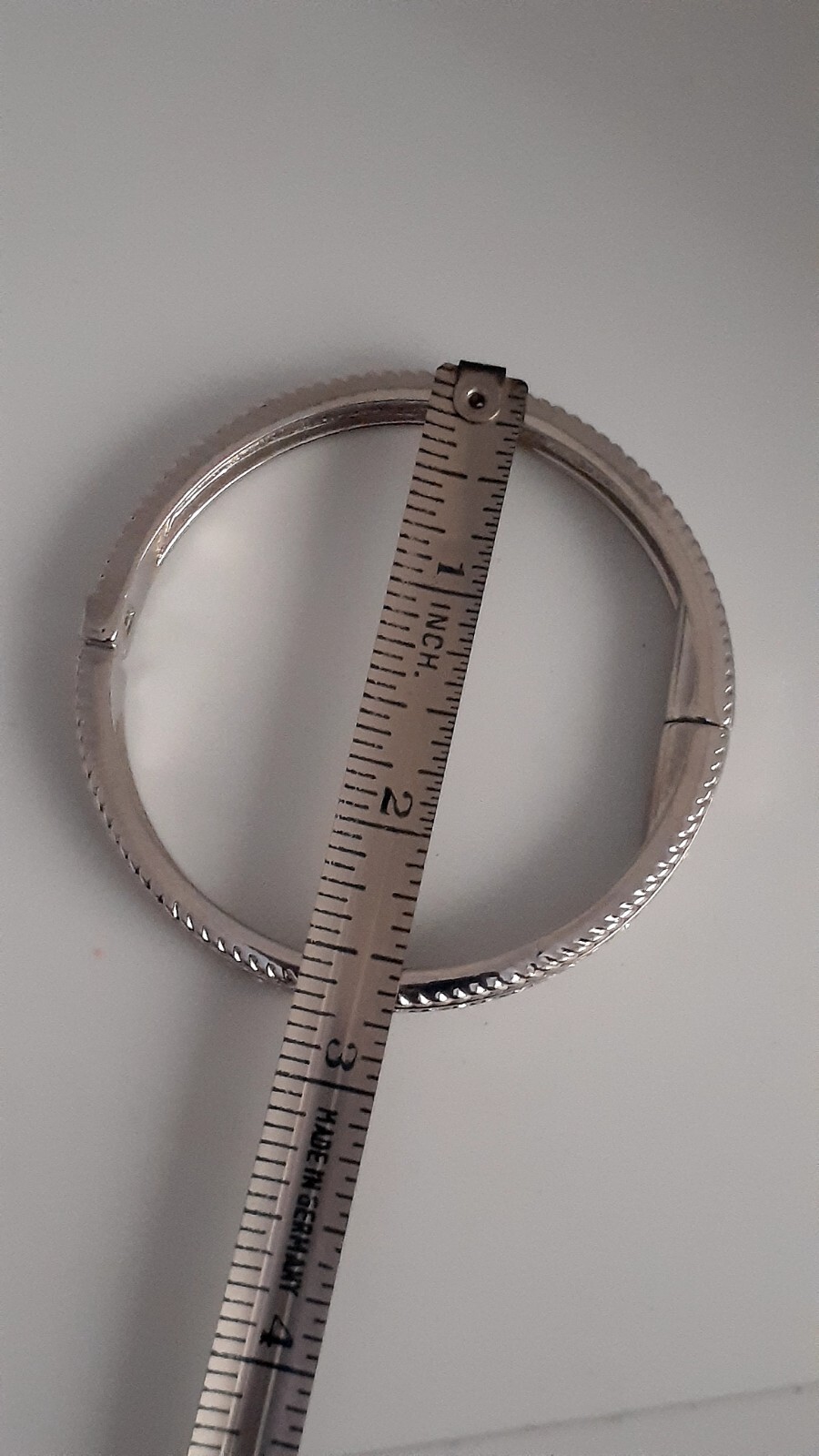 Cubic Zirconia Silvertone Bangle Bracelet. Magnetic closure. Signed China