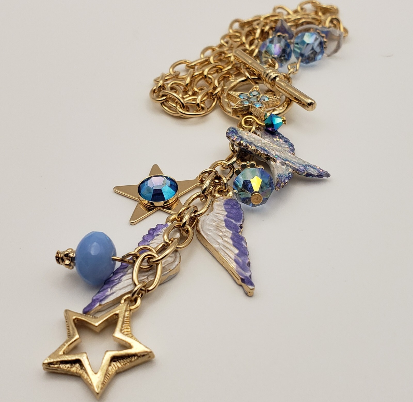 Kirks Folly Forever Angel Wings Charm Necklace Gold Tone 17in Long Blue Crystals