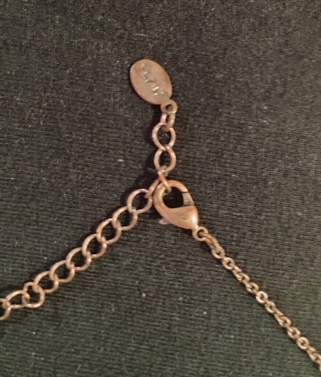 This vintage necklace features amber-color facet beads set in a gold-tone metal.