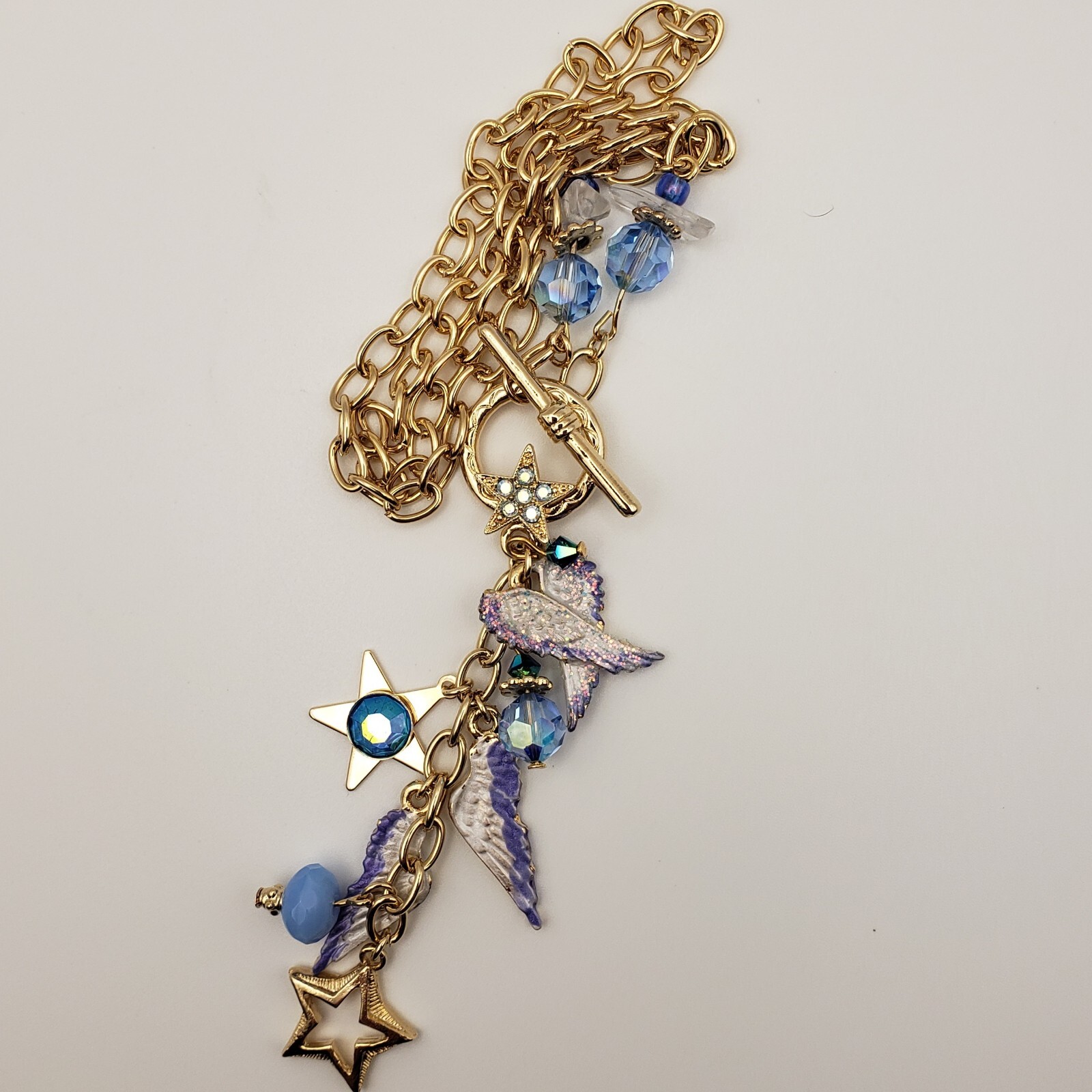 Kirks Folly Forever Angel Wings Charm Necklace Gold Tone 17in Long Blue Crystals