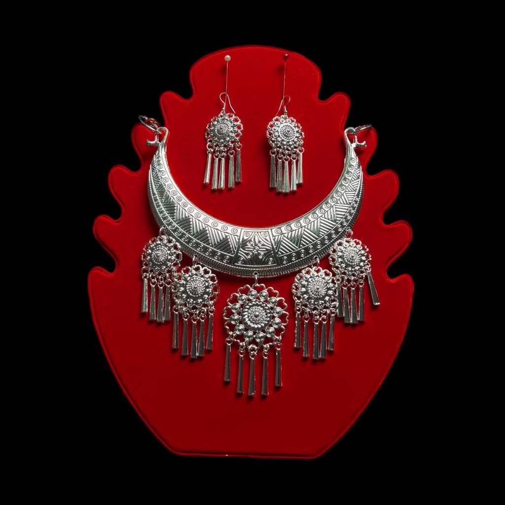 White silver jewelry set, necklace and earrings, with ancient Thai design.