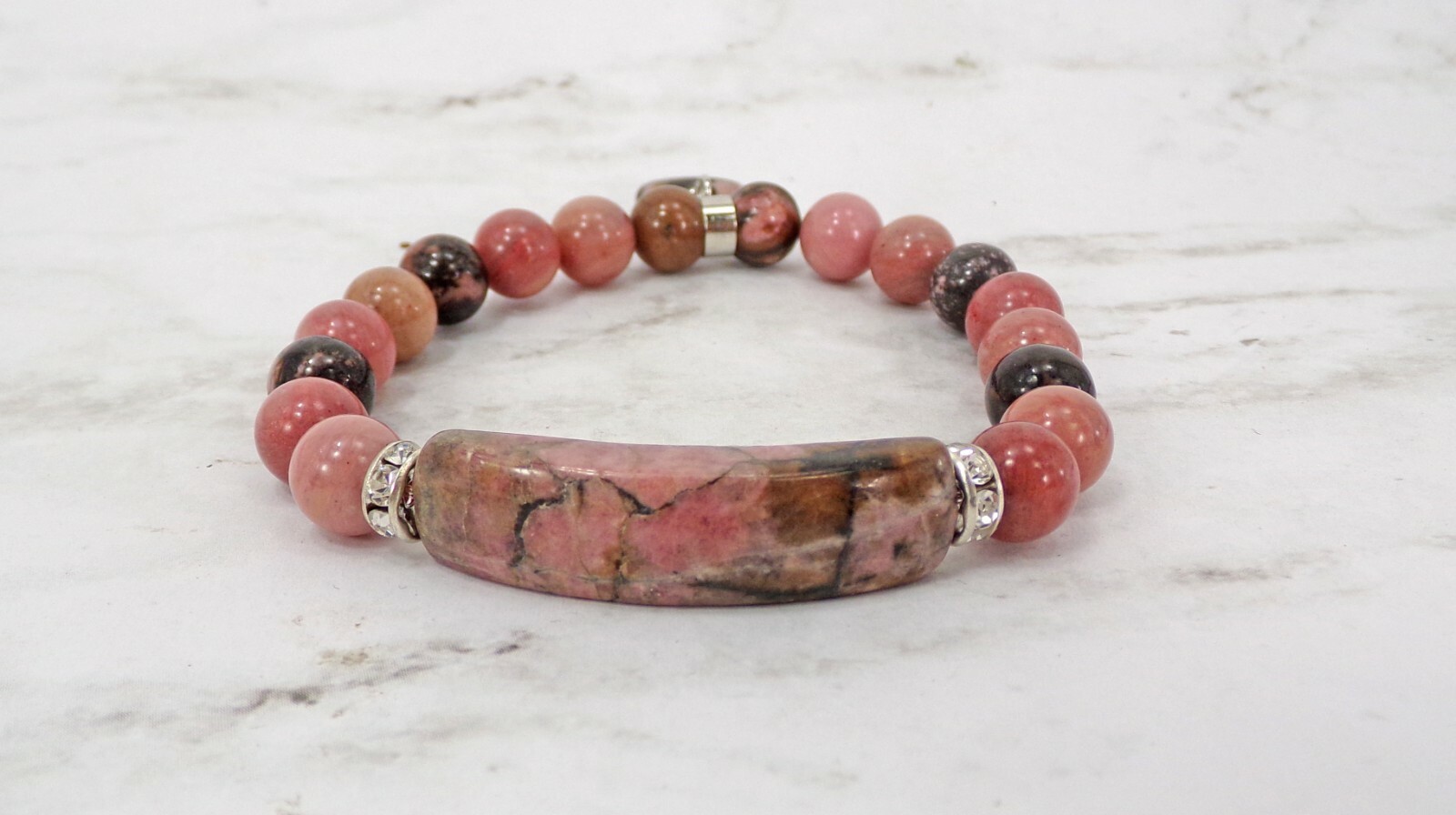 Pink heart charm bracelet made in rhodonite stone beads and crystal spacer beads