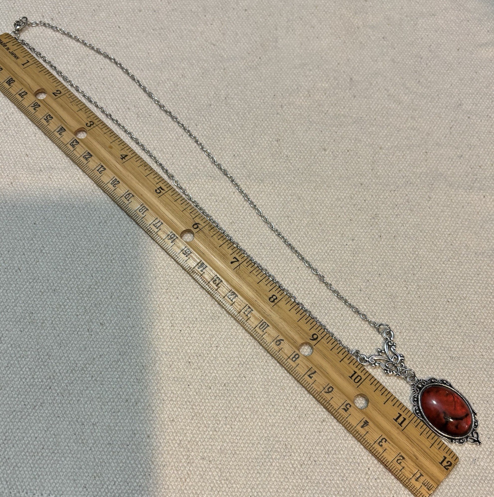 Blood red pendant silver tone chain necklace