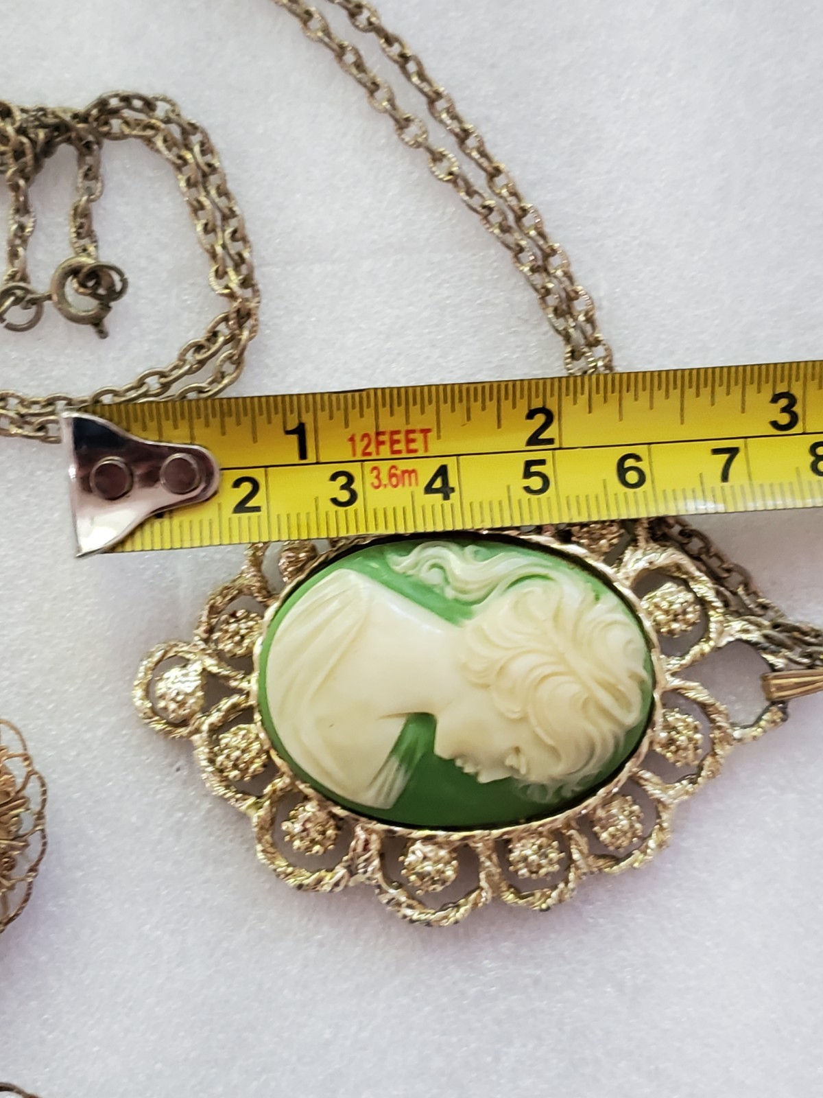 Gold-tone metal green/ivory plastic/resin cameo pendant & clip on earrings