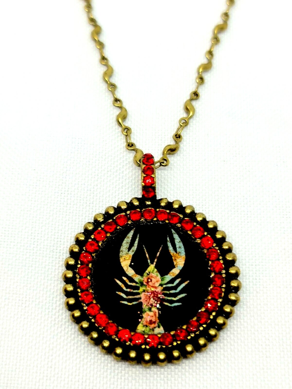 Lovely round Metal Necklace By Michal Negrin Red Crystal Cancer Sign.