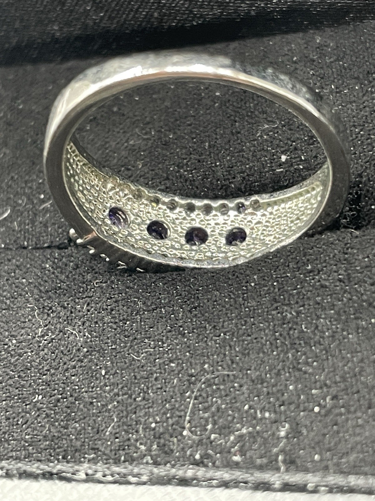Silver ring with unknown 4 purple stones 10 tiny clear chip stones size 9