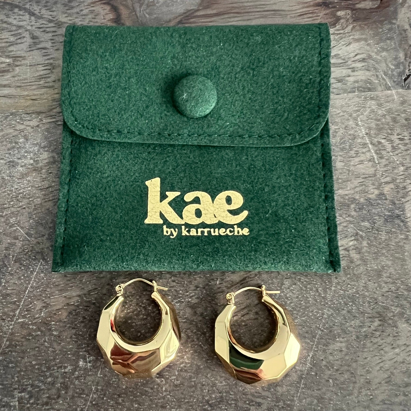 Kae by Karrueche signed gold tone chunky hoop earrings with branded pouch