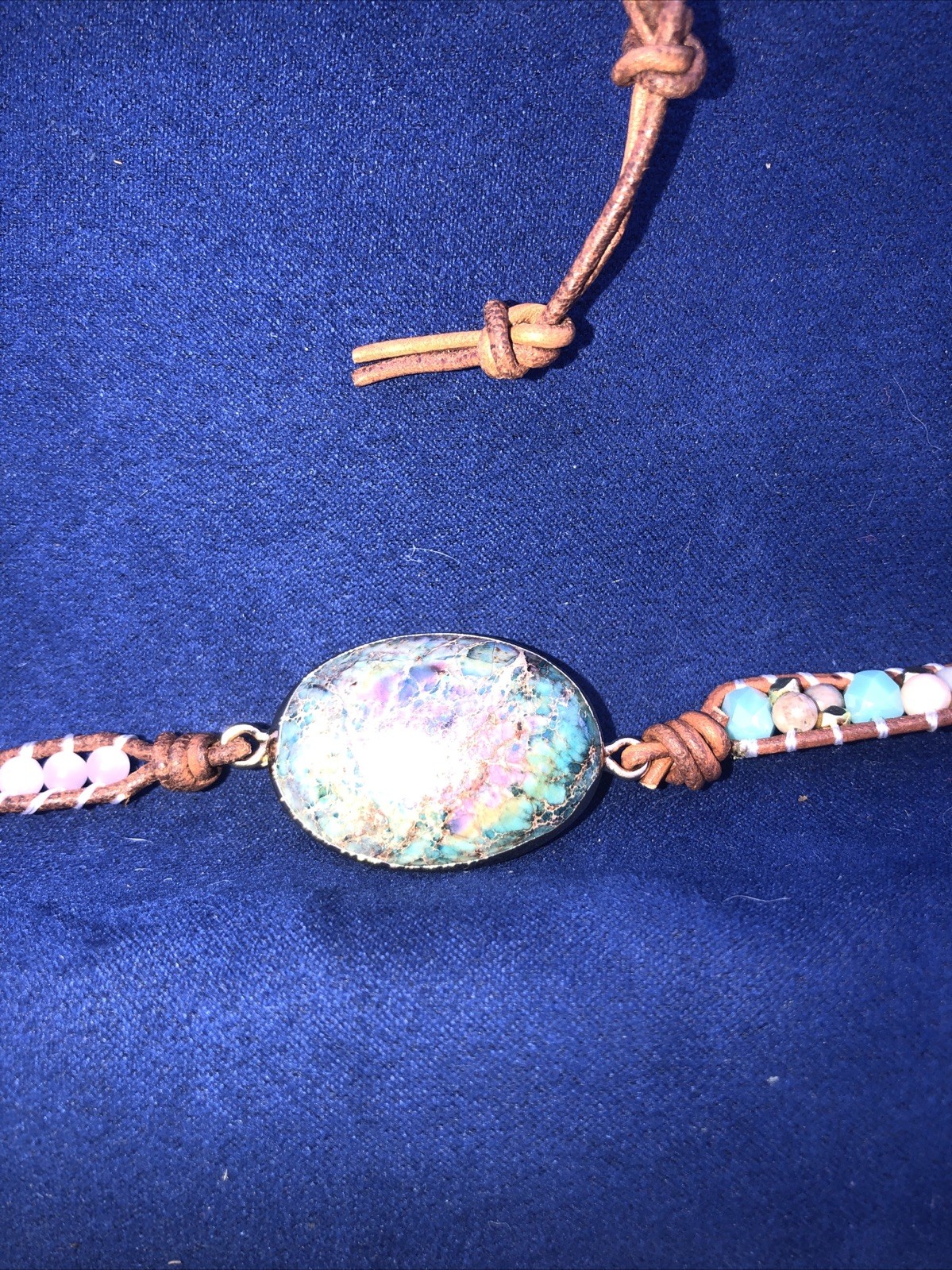 A 37” long necklace ,￼￼ a Bohemian or Hippie emphasizing made of leather, gems.w