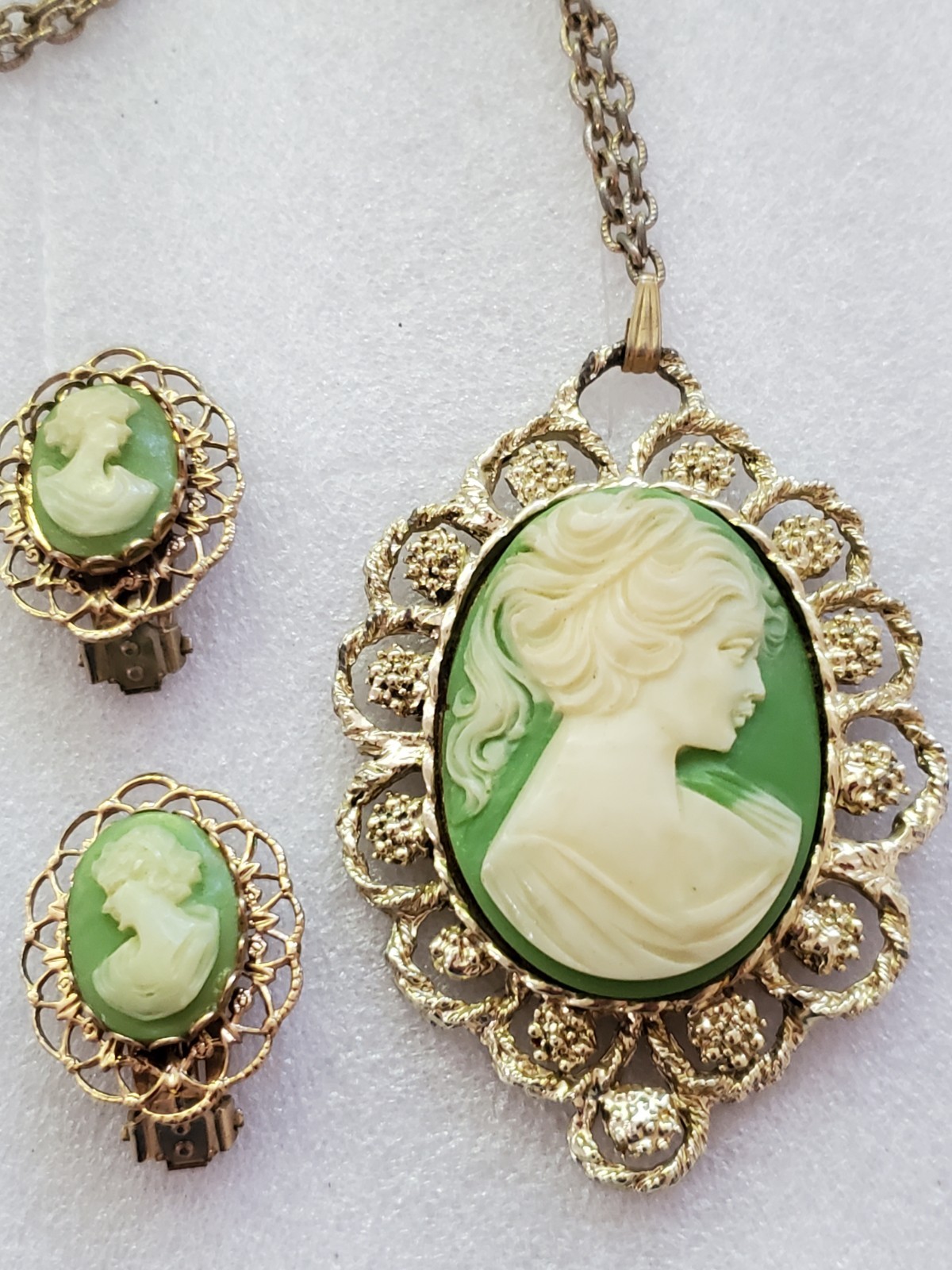 Gold-tone metal green/ivory plastic/resin cameo pendant & clip on earrings