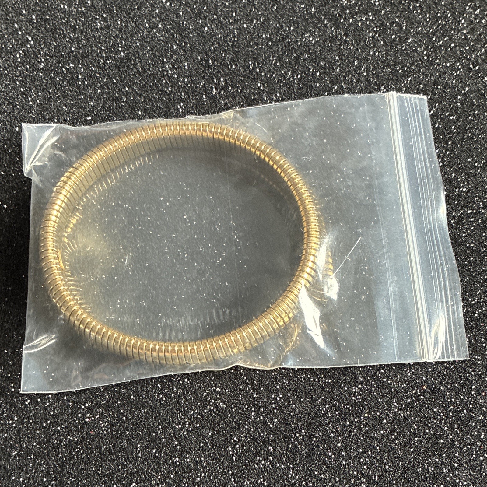 Gold core stretch bracelet by plunder. 7 inch slight stretch layers well with ot
