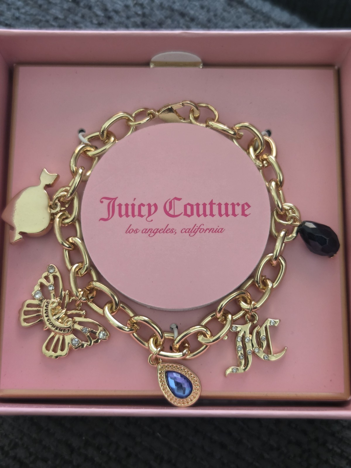 Juicy Couture Gold Charm Bracelet with Blue and Black Accents