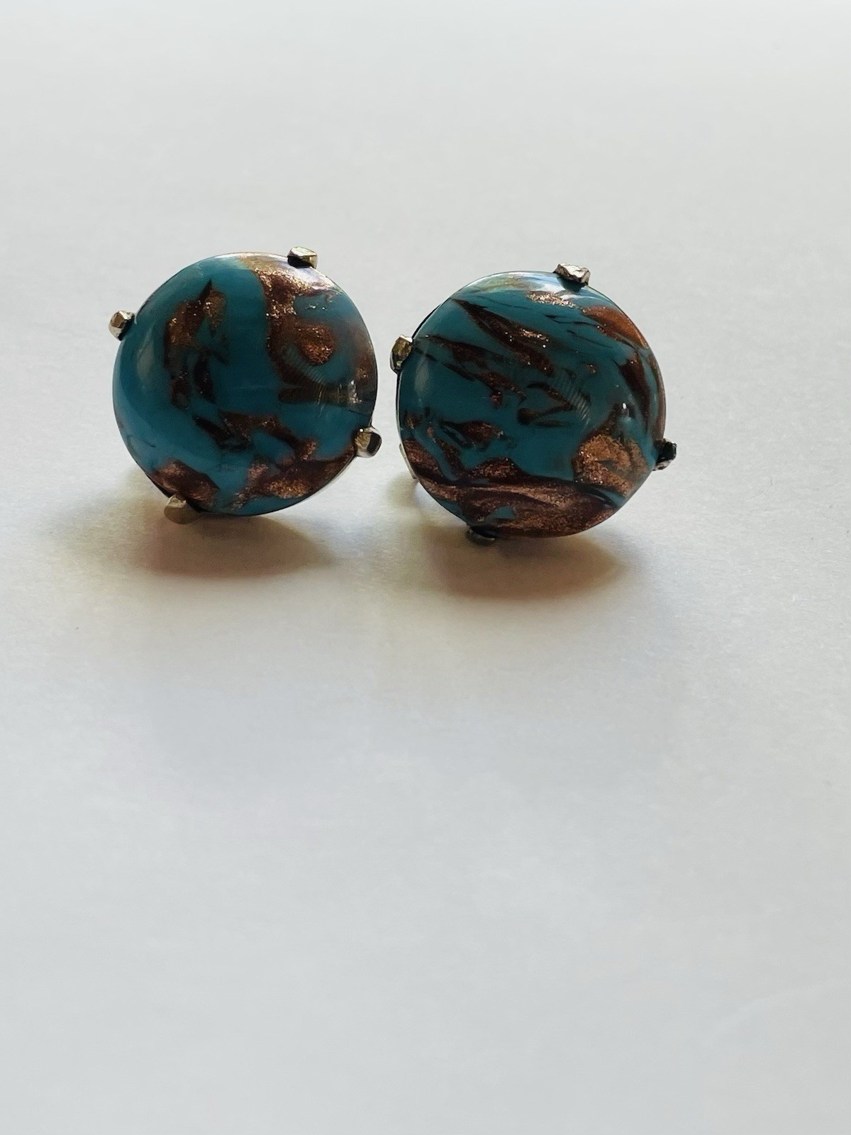 Vintage Crown Trifari round clip-on earrings, featuring turquoise cabochon
