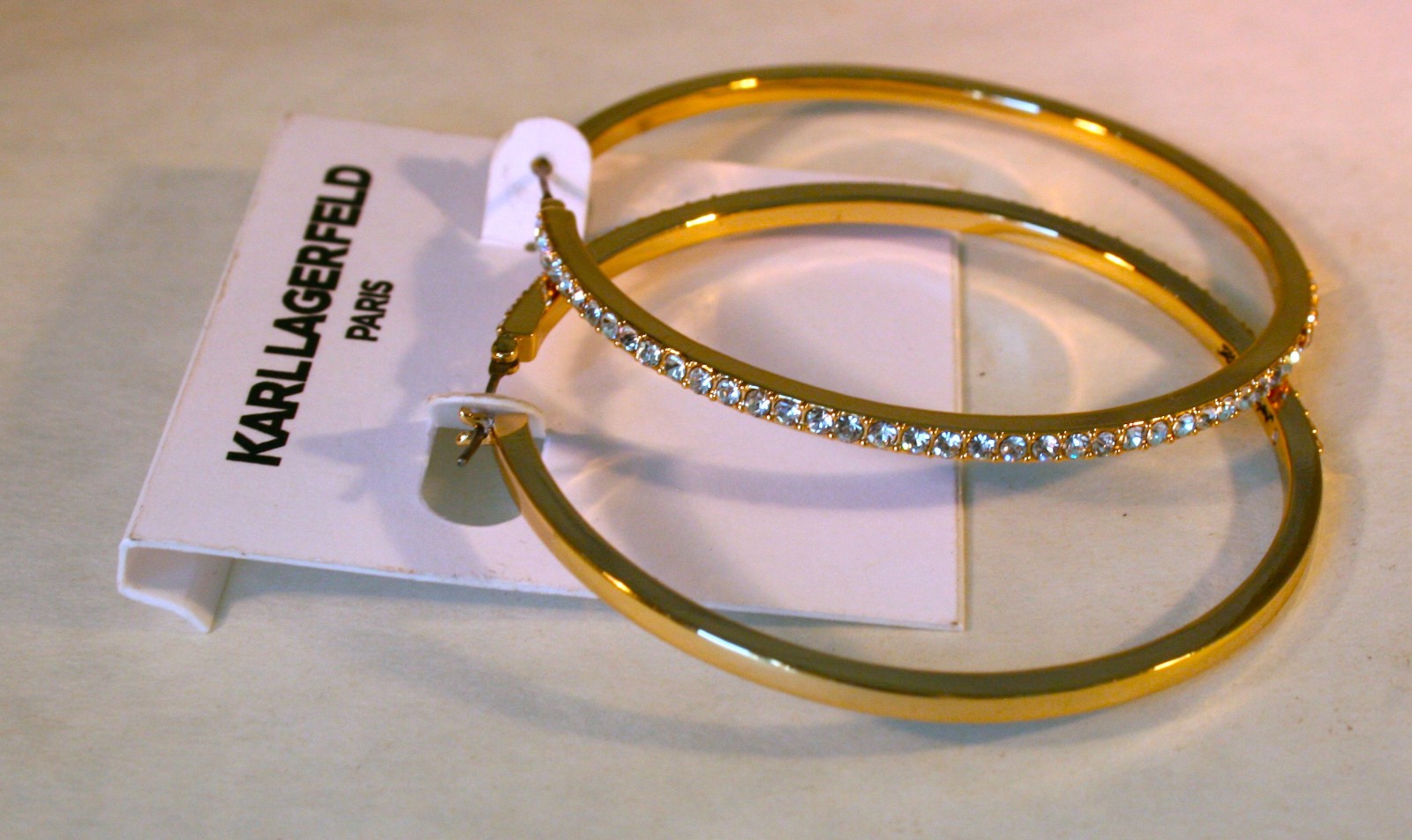 Karl Lagerfeld Paris gold tone Pave crystal edged Hoop Earrings 2 1/2″