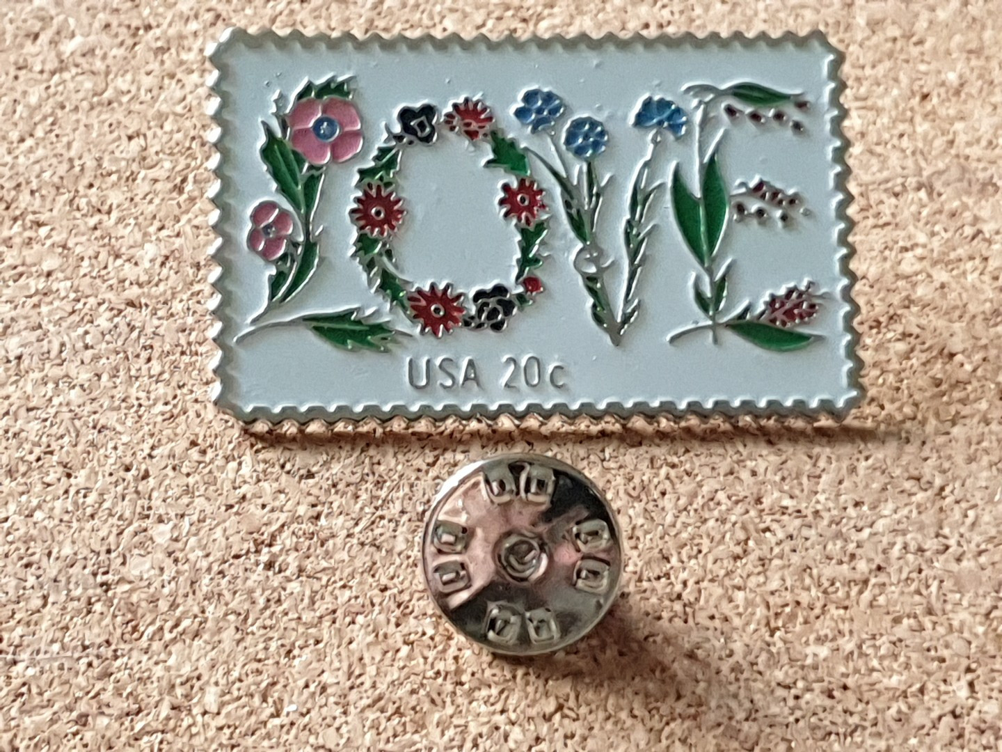 The March Co USPS 20c 1982 LOVE Stamp Floral Embossed Lapel Pin Back