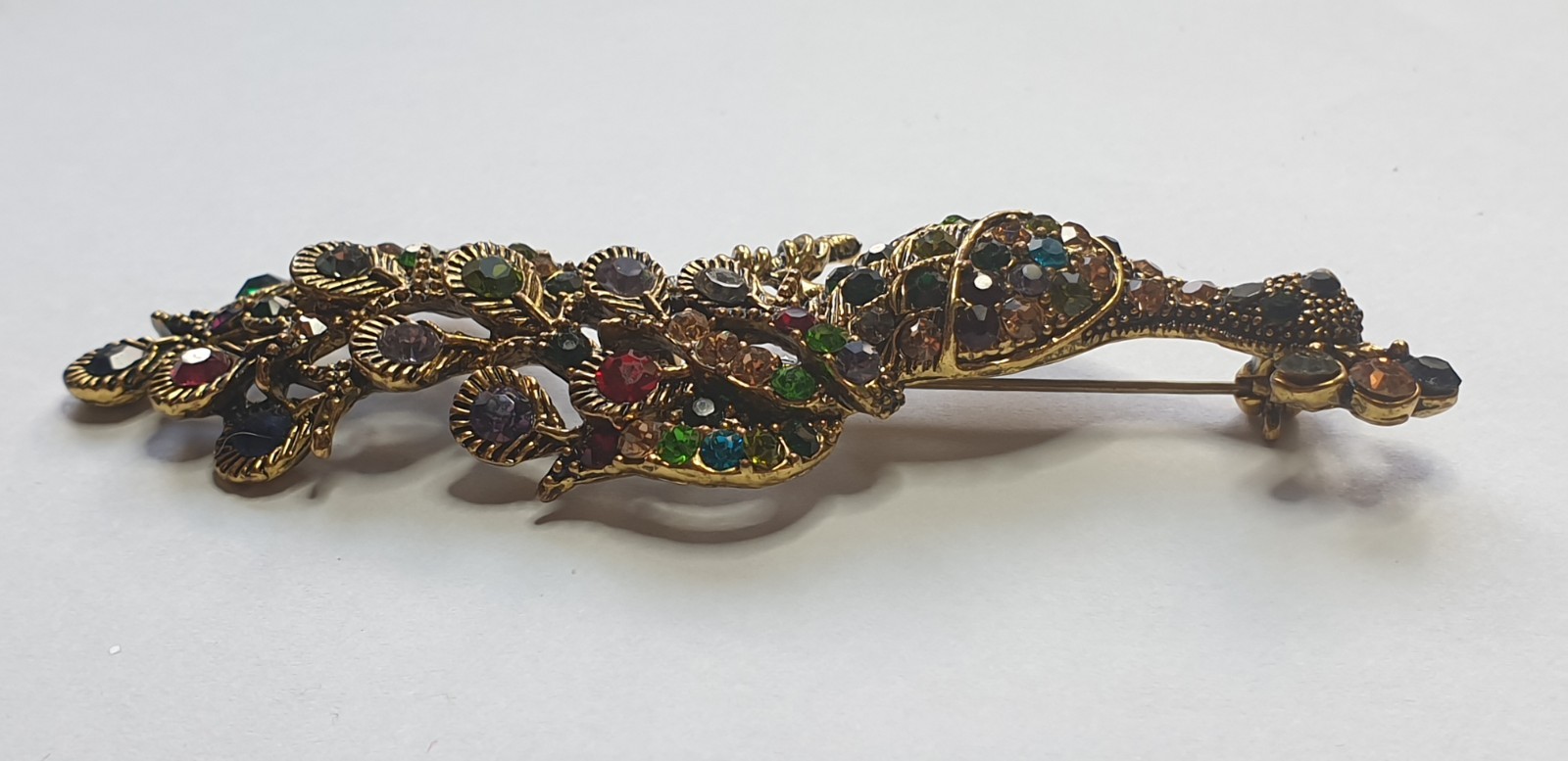 Peacock Brooch. Gold tone with Multicoloured glass beads . 84mm x 28mm.