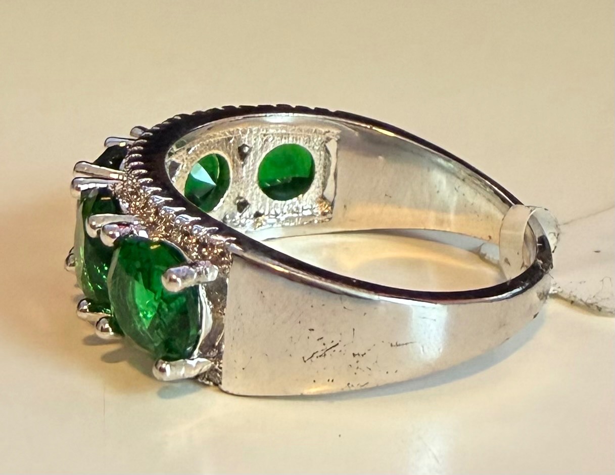 Simulated green diamond ring set in silver tone, size 8.5