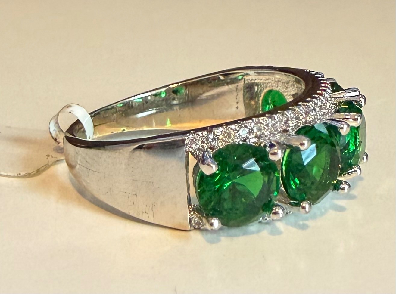 Simulated green diamond ring set in silver tone, size 8.5