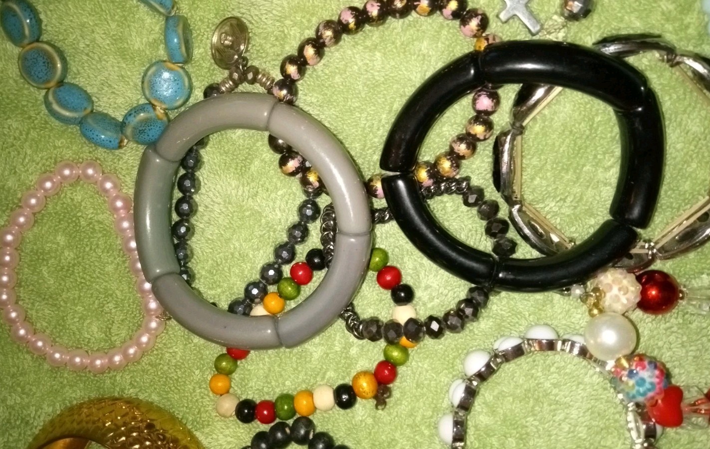 MULTIPLE FASHION BRACELETS MOST STRETCHY BUT SOME PRETTY ONES, SOME SIGNED BRASS