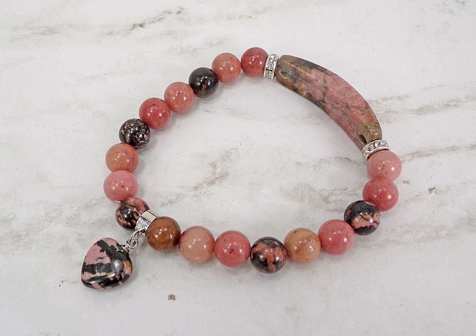 Pink heart charm bracelet made in rhodonite stone beads and crystal spacer beads